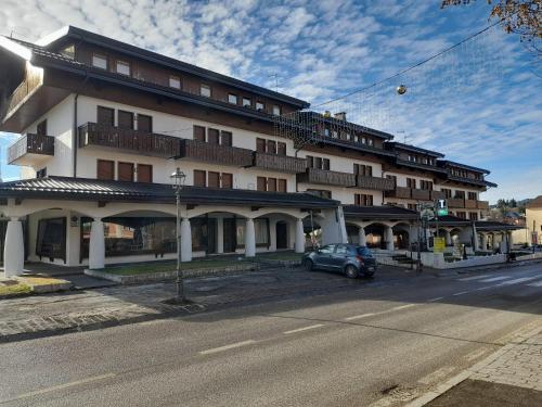 a building with a car parked in front of it at La Casa di Giò -GALLIO CENTRO- in Gallio