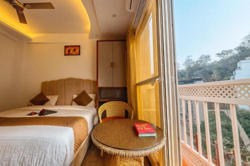 a hotel room with two beds and a balcony at Check Inn Homes, Rishikesh Tapovan in Rishīkesh