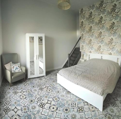 En eller flere senge i et værelse på Ferme du chateau