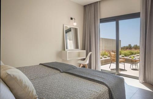 a bedroom with a bed and a view of a patio at Villa Anelle in Karavádhos
