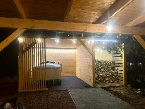 a bathroom with a tub in a room with lights at KASZUBY Oliwkowy domek Niesiołowice na Kaszubach Balia z Jacuzzi Jeziora lasy in Niesiołowice