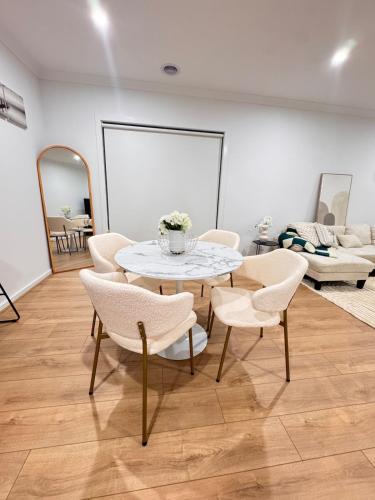 a room with a table and chairs and a couch at Ari Luxe Retreat in Lara