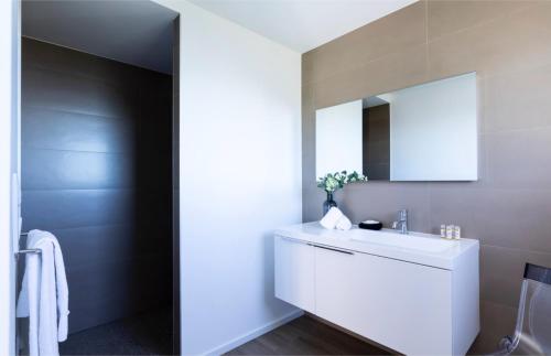 a bathroom with a white sink and a mirror at Villa Supranu in Viggianello