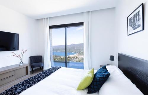 a bedroom with a bed and a large window at Villa Supranu in Viggianello