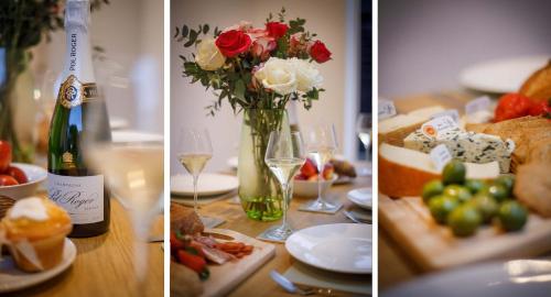 a table with food and a bottle of wine and flowers at Abbotsford House sleeps 8 in York