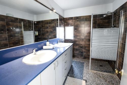 a bathroom with two sinks and a shower at Villa Or - Heated Pool in Eilat