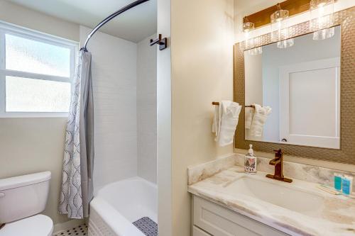a bathroom with a sink and a toilet and a mirror at 8 Mi to Dtwn New Orleans! Newly Renovated Home in Metairie