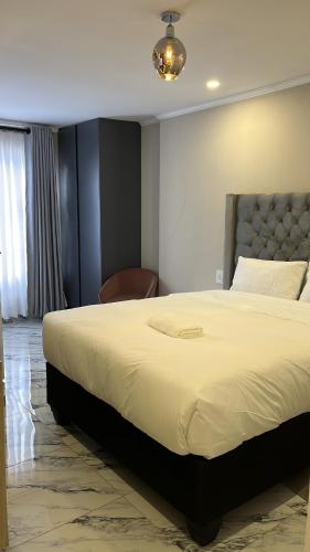 En eller flere senge i et værelse på Southridge Guest House