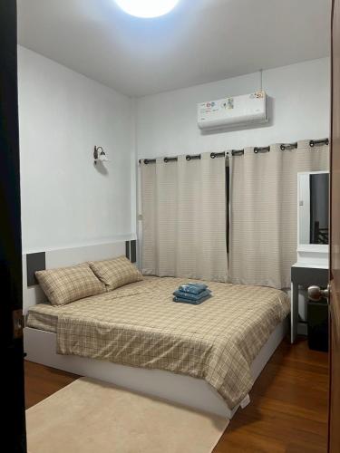 a bedroom with a bed and a television in it at Uncle Matts Cafe and Chill in Chiang Mai