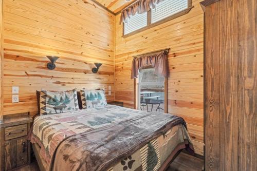 a bedroom with a bed in a log cabin at Laurel Bush Combo - 6 Waterfront Homes, Fish, Hike, and Mountain Views! in Sylva