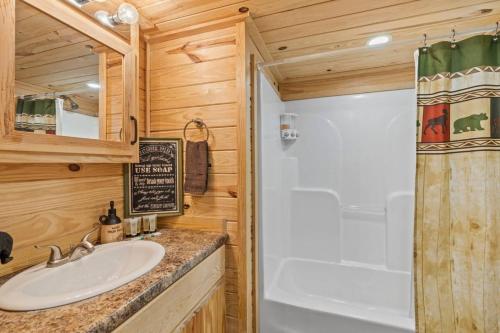 a bathroom with a sink and a shower at Tuck River Magic - 6 Waterfront Homes, Fish, Hike, and Mountain Views! in Dillsboro