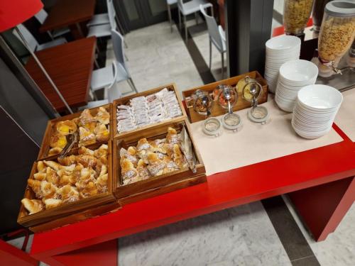 a buffet of food on a red table at Ibis Roma Fiera in Rome