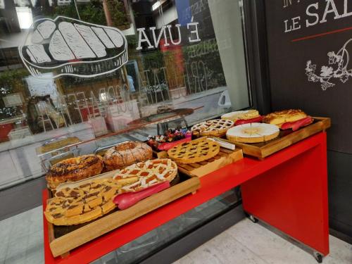 a red counter with different types of bread and pastries at Ibis Roma Fiera in Rome