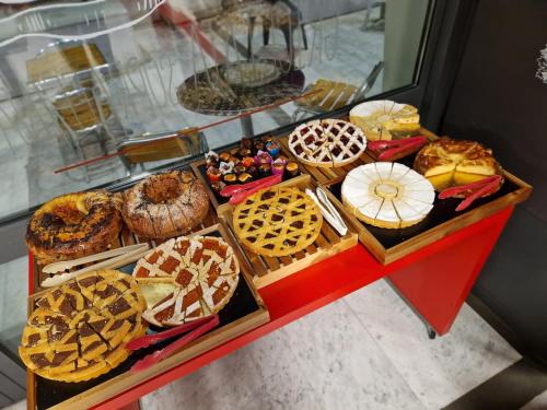 a display case filled with different types of pastries at Ibis Roma Fiera in Rome