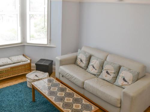 a living room with a couch and a coffee table at The Seahorses - Ukc1067 in Sheringham
