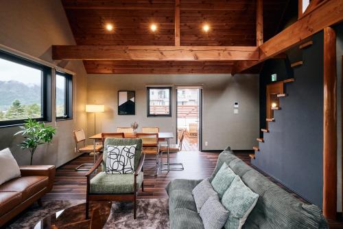 a living room with a couch and a table at THE BLISS FUJI - YAMANAKAKO private Sauna Villa with 100m2 Dog Run in Yamanakako