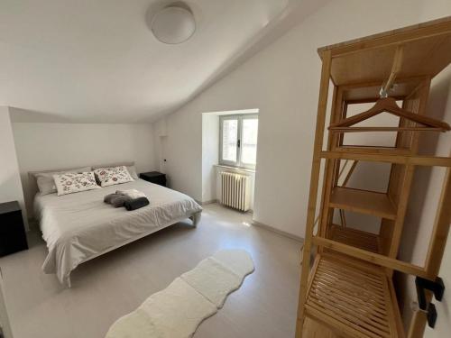 La Casa nel Borgo في نوسيرا أومبرا: غرفة نوم بسرير وسلم خشبي