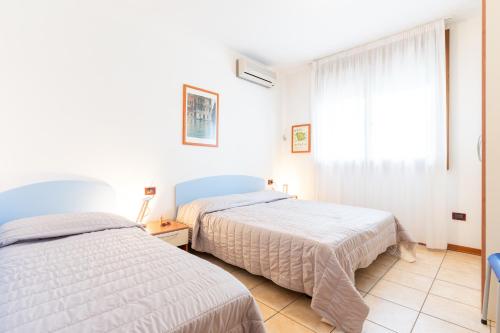 Postel nebo postele na pokoji v ubytování Olmi Lido Altanea