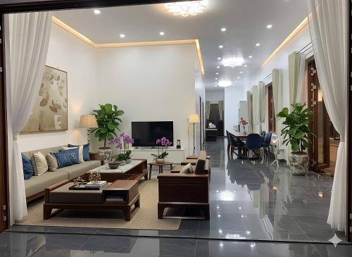 a living room with a couch and a tv at Pin's House in Bao Loc