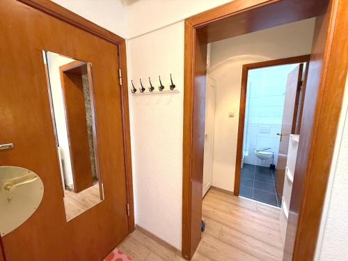 a bathroom with a toilet and a sink and a mirror at Haus Solymar, Whg 44 in Grömitz