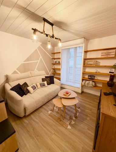 a living room with a couch and a table at L'Escapade Pannessac troisième étage in Le Puy-en-Velay