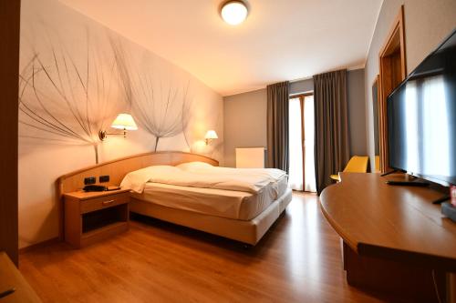 Voodi või voodid majutusasutuse Hotel Piuro toas