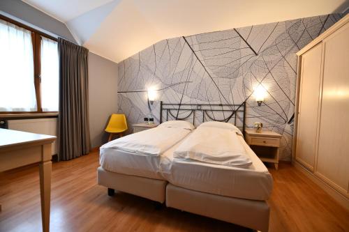 Postel nebo postele na pokoji v ubytování Hotel Piuro