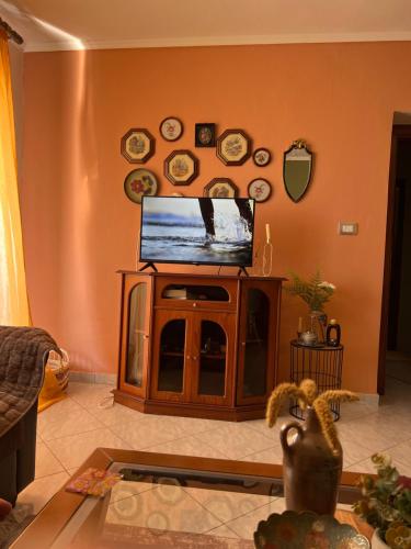 a living room with a flat screen tv on a stand at 4 Seasons Apartment in Leskovik
