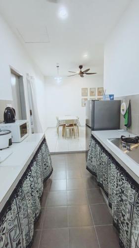 a kitchen with a sink and a table at Townixi Stay in Kampong Jelatang