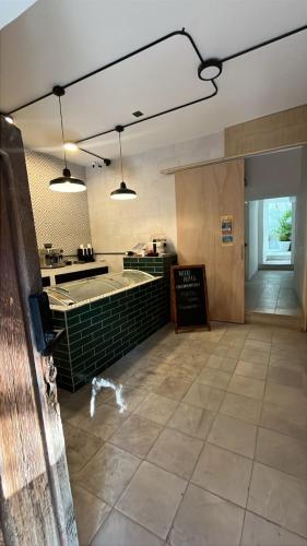 a large room with a kitchen and a counter at NIDO Hotel in San Miguel de Allende