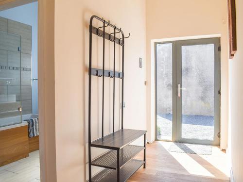 a wooden bench in a room with a window at Beckside House in Dalton in Furness