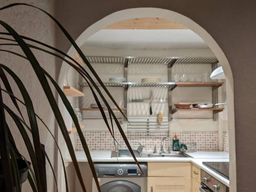 a kitchen with a sink and a washing machine at Cosy 1 bedroom flat close to city centre in Edinburgh