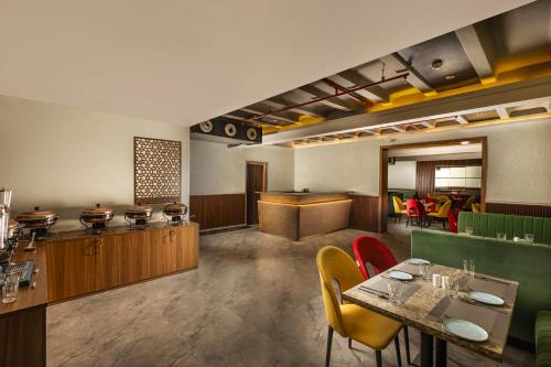 a restaurant with a table and chairs in a room at asar Capoors Hotel by Orion Hotels in Lucknow