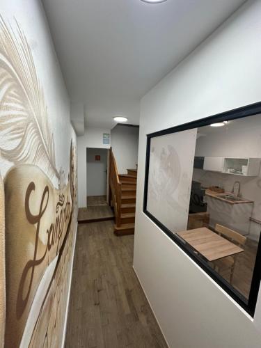 a room with a wall with a sign on it at Suite 1- La Petite Auberge in Langres