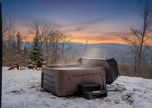 a hot tub sitting on top of a snow covered field at Modern Comfort - Spa - Mountain - Chalet ALBA in Saint Come