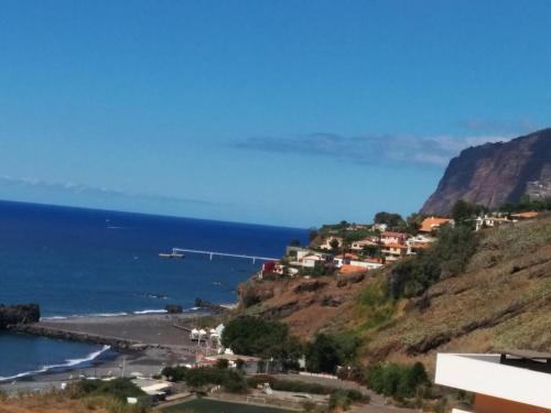a town on a hill next to the ocean at Villa Formosa in Funchal