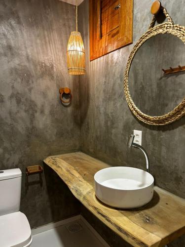 a bathroom with a sink and a toilet at Chalé Brisa do Pontal in Fortim