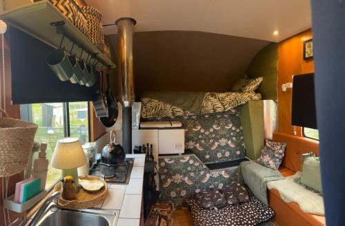 a tiny house with a couch and a bed at Flowerdew Farm in Puncknowle
