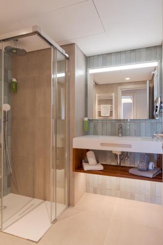 a bathroom with a shower and a sink at Hapimag Resort Albufeira in Albufeira