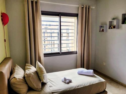 a small room with a bed and a window at 3BR Near Airport Secure,Equipped stay and transit in Nouaseur