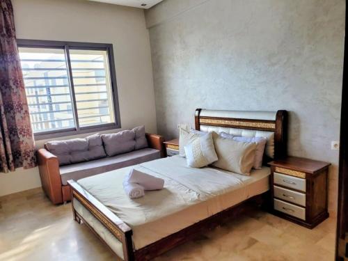 a small bedroom with a bed and a couch at 3BR Near Airport Secure,Equipped stay and transit in Nouaseur