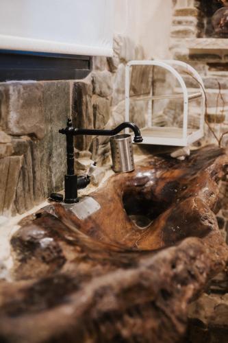 a bathroom sink with a faucet on top of it at Handmade semi basement in Ioannina