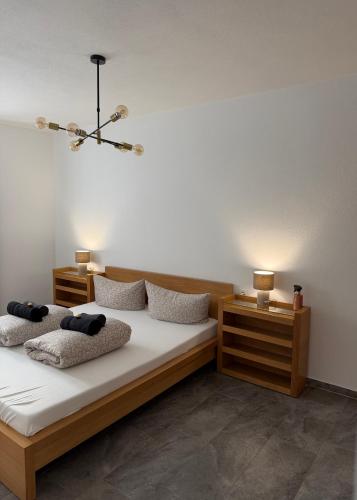 a bedroom with two beds and two night stands at Apartment Oberleins III in Arzl im Pitztal
