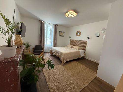 a bedroom with a bed and a chair in it at Suite 3- La Petite Auberge in Langres