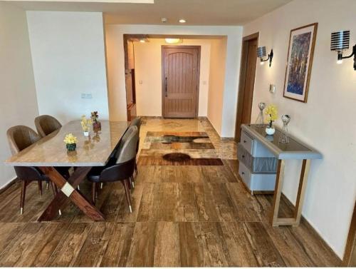 a dining room with a table and chairs and a wooden floor at Relax Lodge Family Guest House in Islamabad