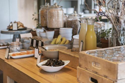 a wooden counter with food and drinks on it at Westmorland Hotel Tebay in Tebay