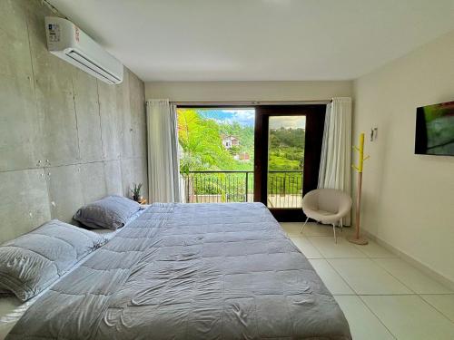 En eller flere senge i et værelse på Casa Bambu – Seu refúgio na serra de Areia