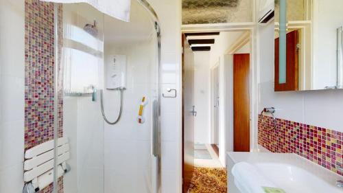 a bathroom with a shower and a sink at C16 Treverbyn, Riviere Towans in Hayle