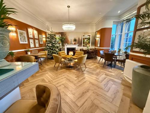 a living room with a christmas tree in the middle at Seabank House Hotel in Nairn