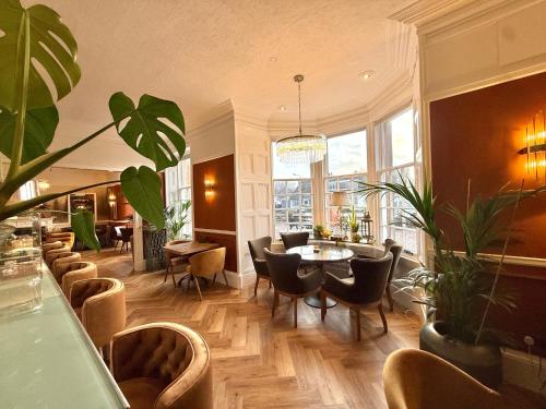 a restaurant with chairs and a table in a room at Seabank House Hotel in Nairn